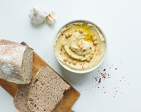 Photo of bread and hummus on a table