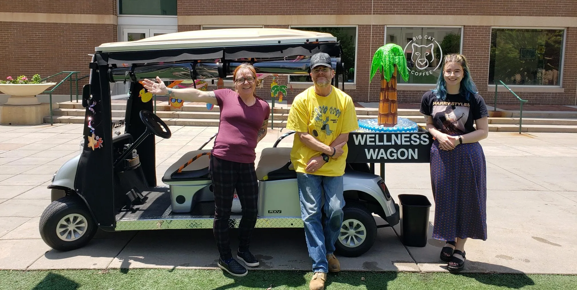 Welcome Wagon Employees standing in front of a golf cart. 